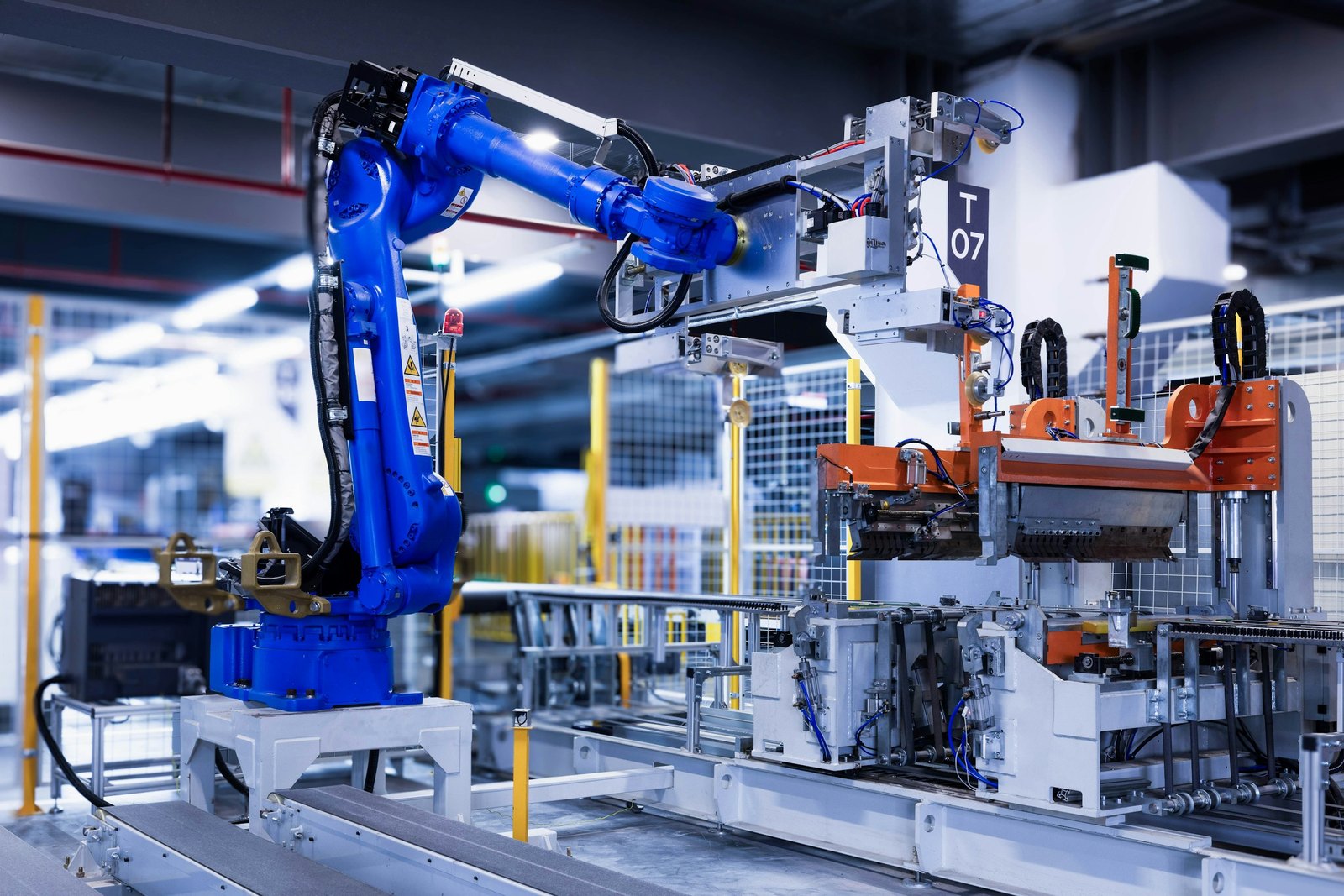 Cánh tay robot công nghiệp màu xanh trong xưởng